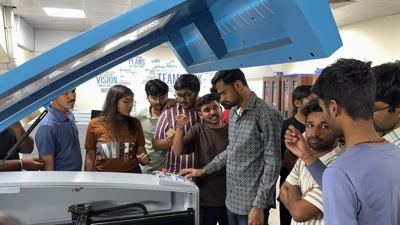Students watching a machine demonstration.