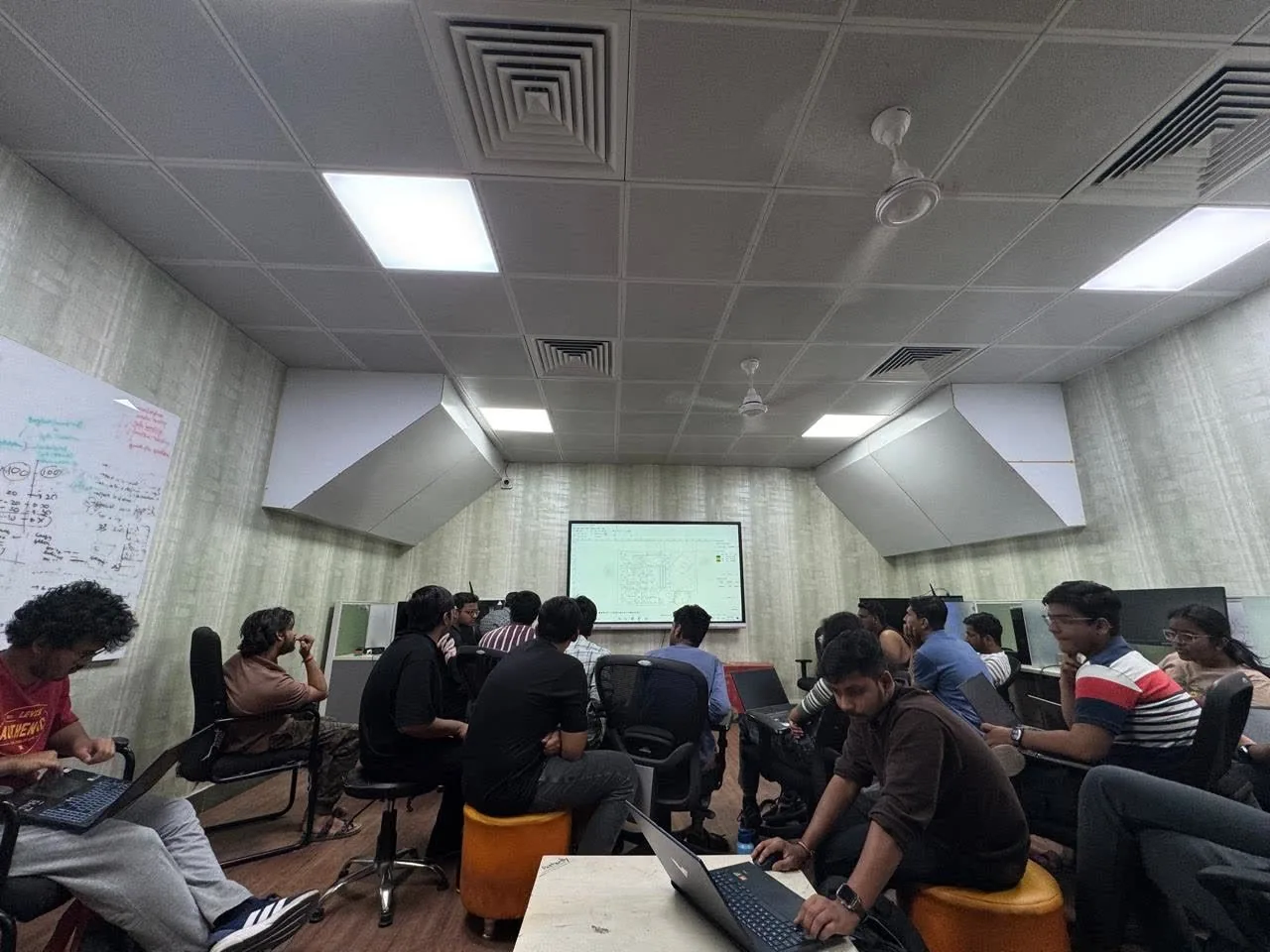 Students seated with laptops during a session in the lab.
